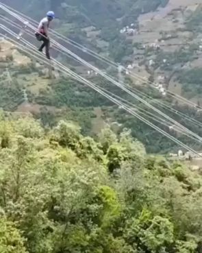 Lineman sliding down the power lines