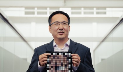 Dr. Kaida Xiao, Professor of Color and Imaging Science at the University of Leeds, holds a color chart.